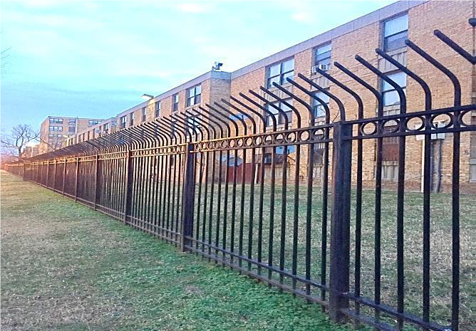 A metal fence that wraps around housing units.