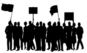Group of people--silhouettes--holding up signs and flags