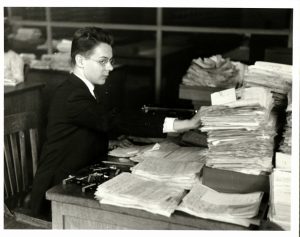 Clerk processes immigration paperwork, Ellis Island, 1930s. Source: United States Citizenship and Immigration Services History Office and Library.