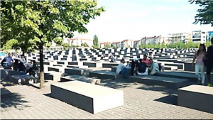 Visitors resting on the concrete slabs of the Memorial to the Murdered Jews of Europe. Photo by Amber Kalb.